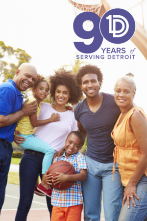 Happy multigenerational African American family standing on a basketball court smiling